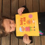 Picture of a child holding baby + me, a unique story book for soon to be big brothers and sisters.